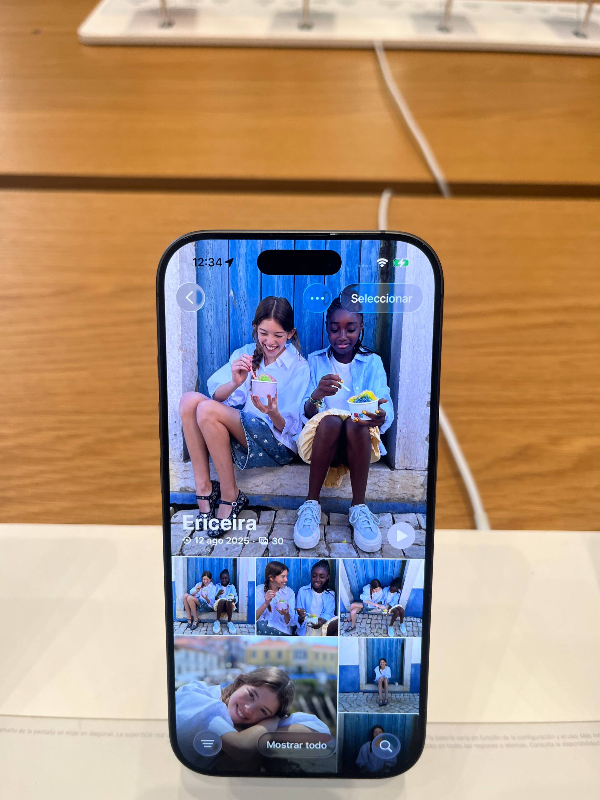 The Photos app grid inside the demo unit, part of a 30-photo "Ericeira" memory dated 12 August 2025.